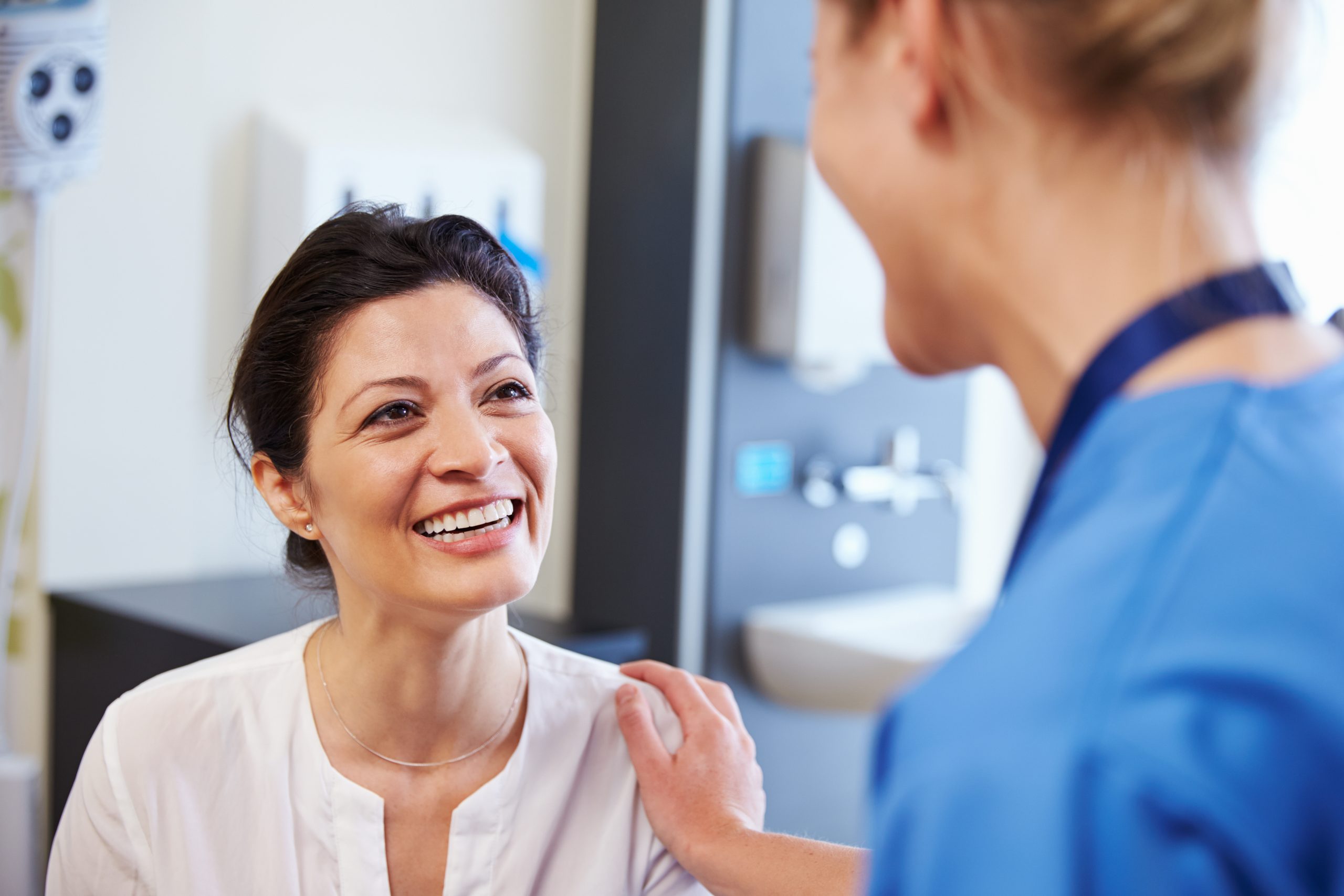 Female doctor reassuring female patient